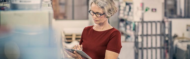 Frau mit Brille notiert etwas