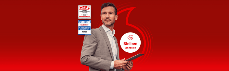 Mann im grauen Anzug mit Tablet vor rotem Hintergrund. Vodafone-Werbung mit Auszeichnungen und Slogan "Bleiben lohnt sich".