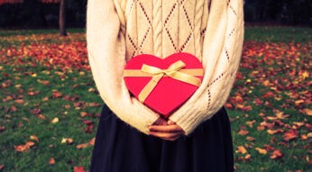 Woman with heart shaped box in park