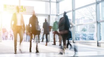 blurred people walking in a modern hall