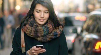 Junge Frau nutzt den Google Kalender auf ihrem Smartphone.