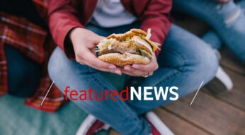 Tasty burger in woman's hands. Takeaway junk food