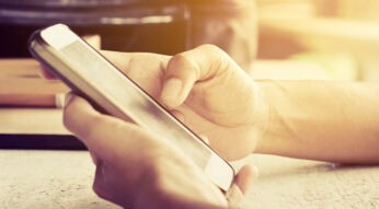 Auf dem Display des Smartphones mithilfe von SwiftKey etwas eintippen.