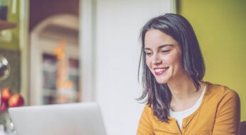 Junge Frau nutzt Google-Chrome-Erweiterung am Laptop.