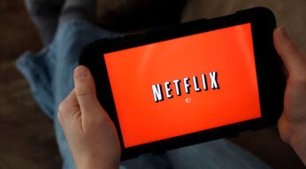 Mann schaut Netflix auf seinem Tablet.