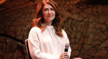Jewel Staite sitzt bei einem Auftritt auf der FedCon 29 auf einem Stuhl samt Mikro.