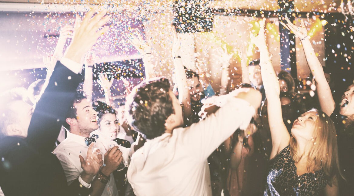 Group of hipsters throwing confetti at a party in celebrations
