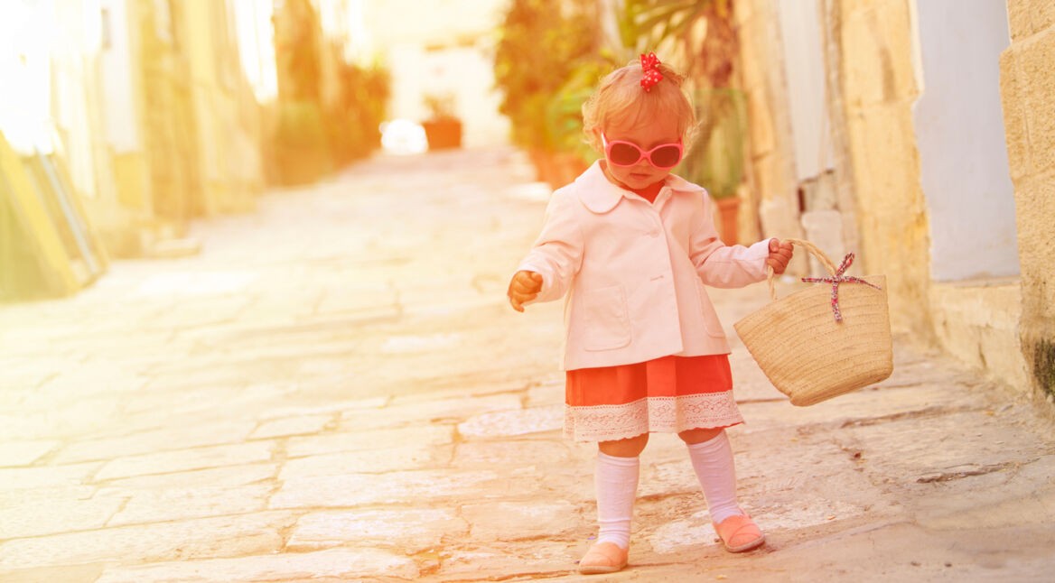 cute little girl walking in the city