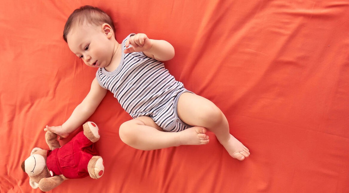 Cute baby is happy in bed