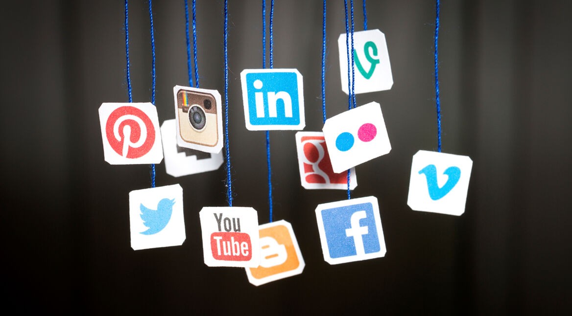 Popular social media website logos printed on paper and hanging