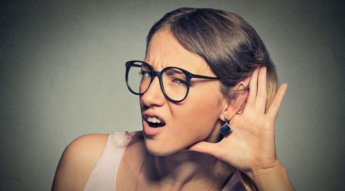 nosy woman hand to ear gesture or hard to hear concept