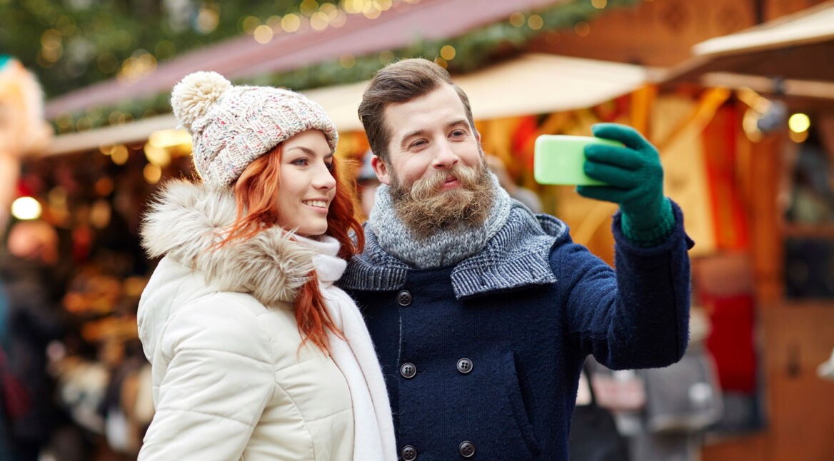 couple taking selfie with smartphone in old town