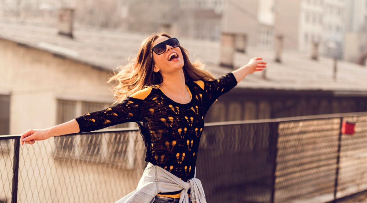 Happy hipster woman having fun on a terrace.