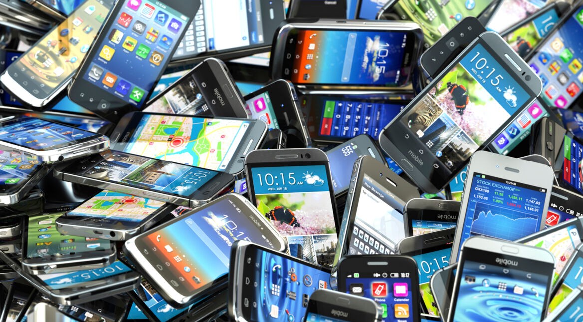 Mobile phones background. Pile of different modern smartphones.