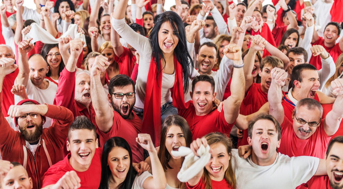 Large group of sport fans cheering. Isolated on white.