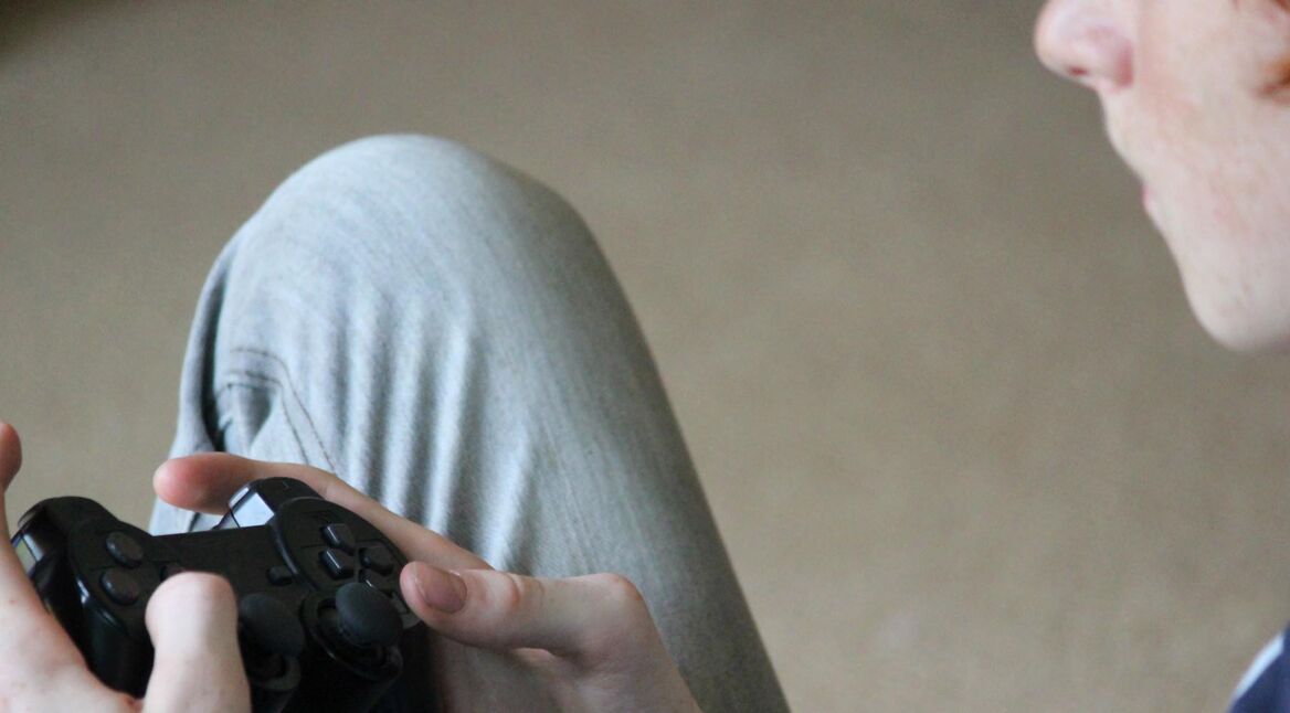 Image of boy playing computer game, gaming controller, video game
