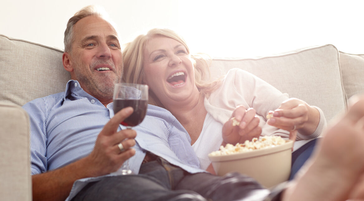 Mature couple enjoying watching movie