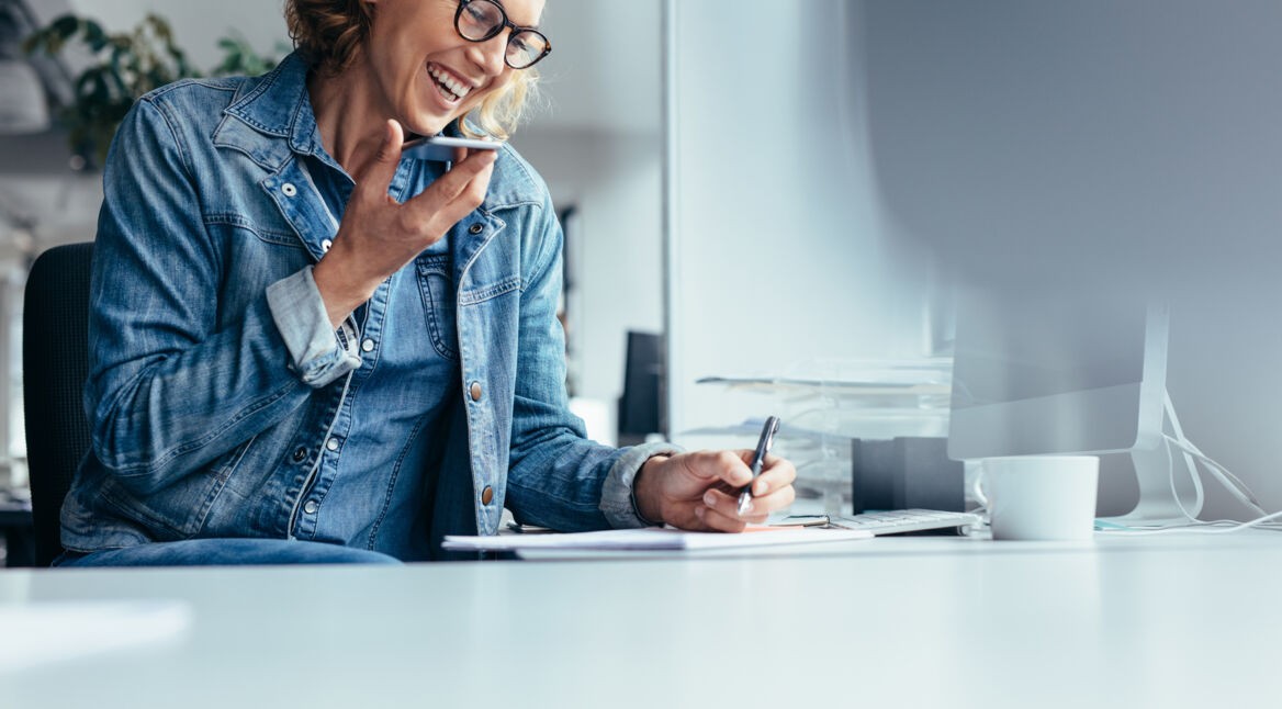 Smiling young businesswoman working at her desk