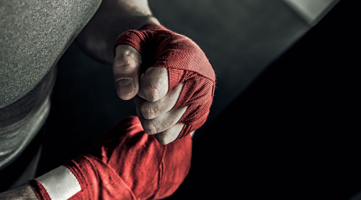 Closeup hand of boxer with red bandages