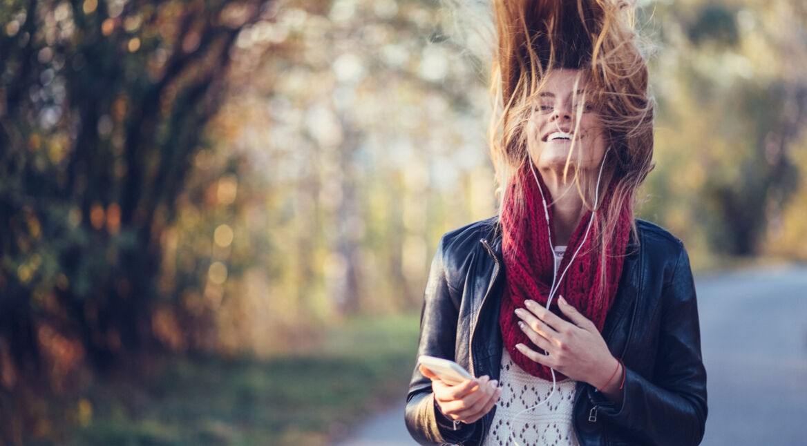 Happy girl shaking head to music