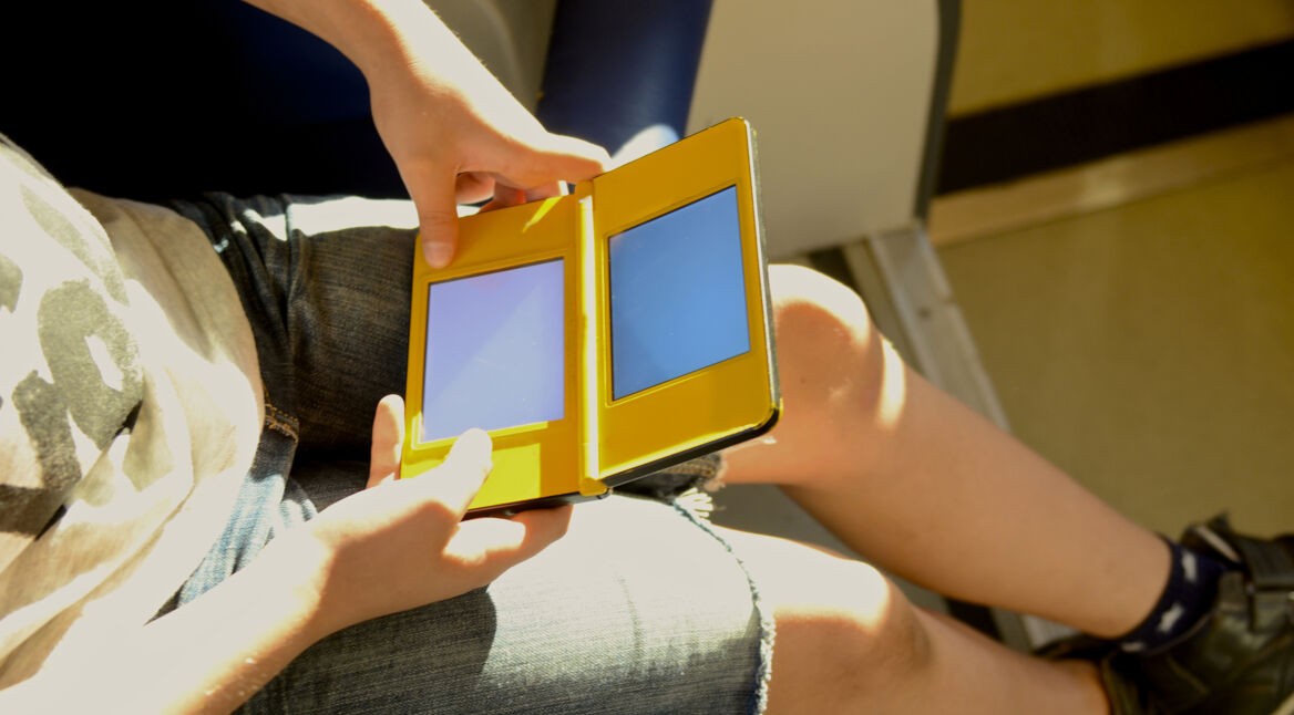 boy play with handheld videogames console