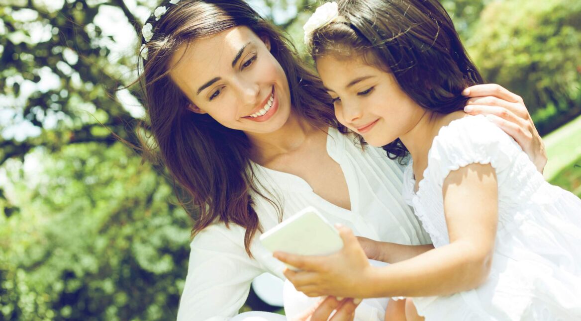 Mom and daughter looking smartphone
