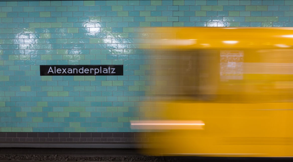 Yellow subway train in motion on Berlin Alexanderplatz underground station.