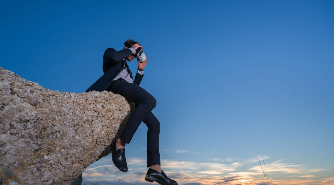 businessman on the top of a high mountain
