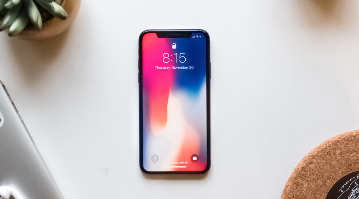 Das neue iPhone X liegt auf einem weißen Schreibtisch.