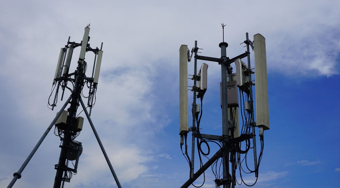 Cell phone telecommunication tower with clouds,blue sky