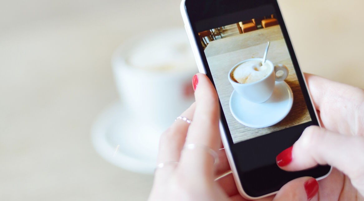 Smartphone taking picture from a coffee