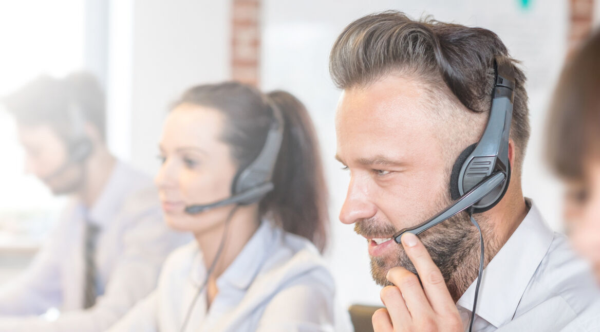 Call center worker accompanied by his team.