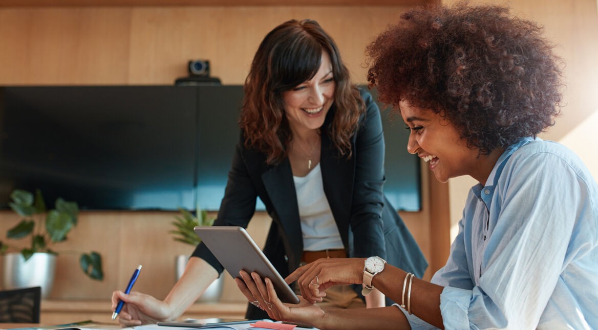 Creative female executives using digital tablet in office
