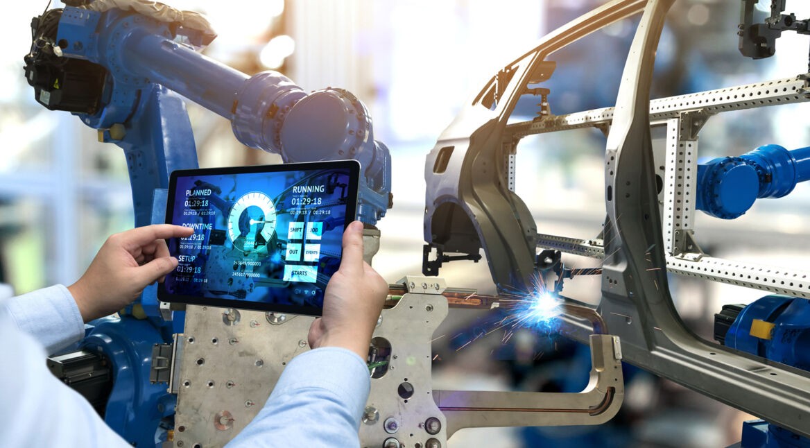 Engineer hand using tablet with machine real time monitoring system software. Automation robot arm machine in smart factory automotive industrial Industry 4th iot , digital manufacturing operation.