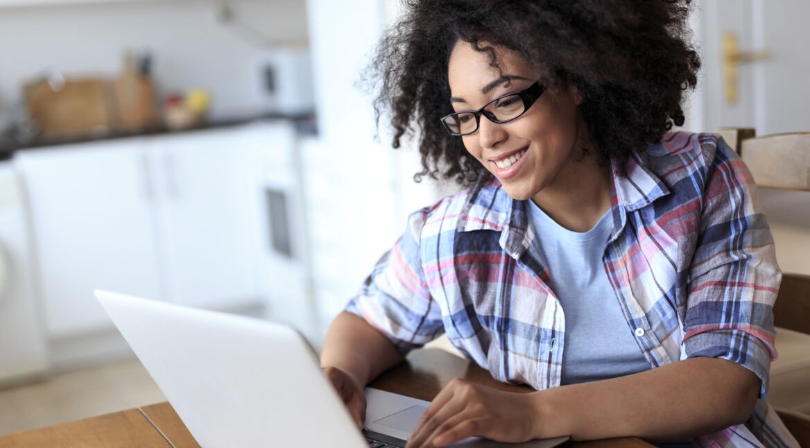 Woman with eyeglasses using laptop at home