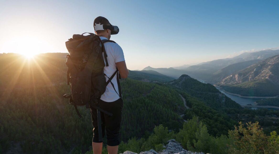 Climber enjoys the view from the top of the mountain