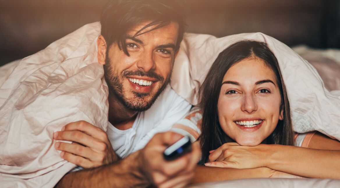 Ein junges Pärchen schaut sich die Amazon Prime Video Neuheiten an