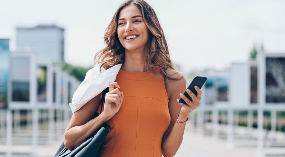 Junge Frau lädt iOS 12 auf ihr Smartphone herunter.