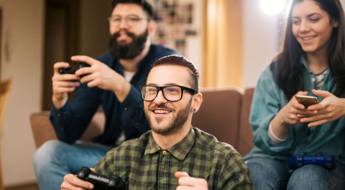 Freunde zocken Spiel mit PS4-Controllern.