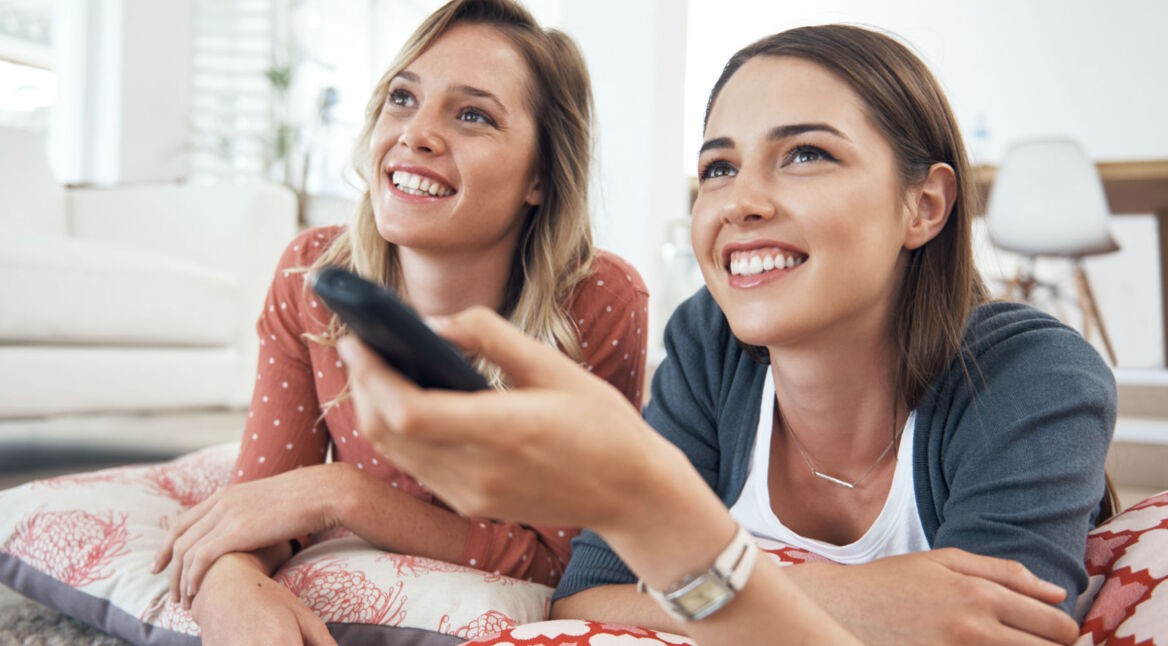 Freundinnen schauen Amazon-Prime-Serie am Fernseher.