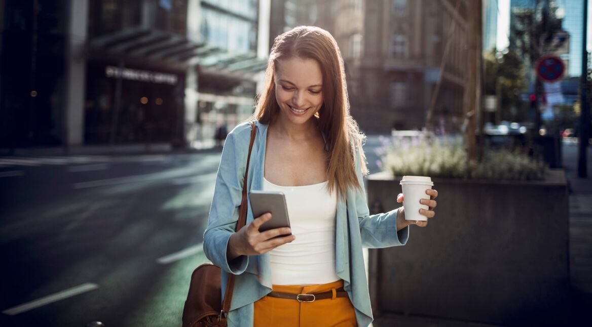 Junge Frau liest eine Nachricht auf WhatsApp