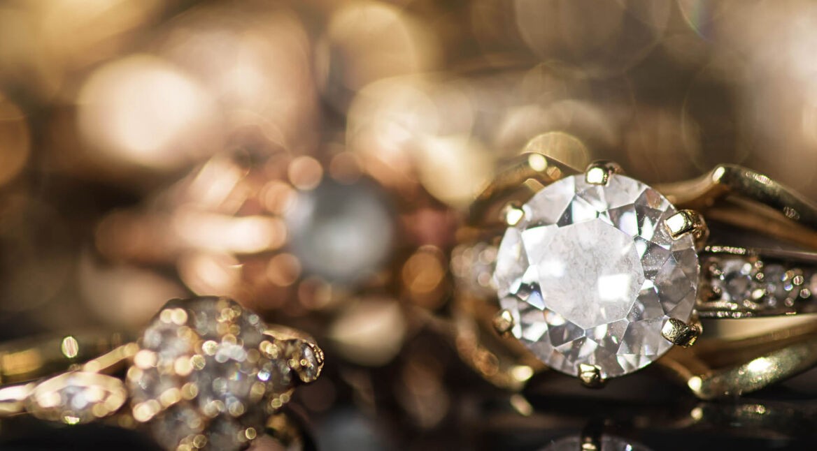 Goldene Ringe liegen auf schwarzer Oberfläche