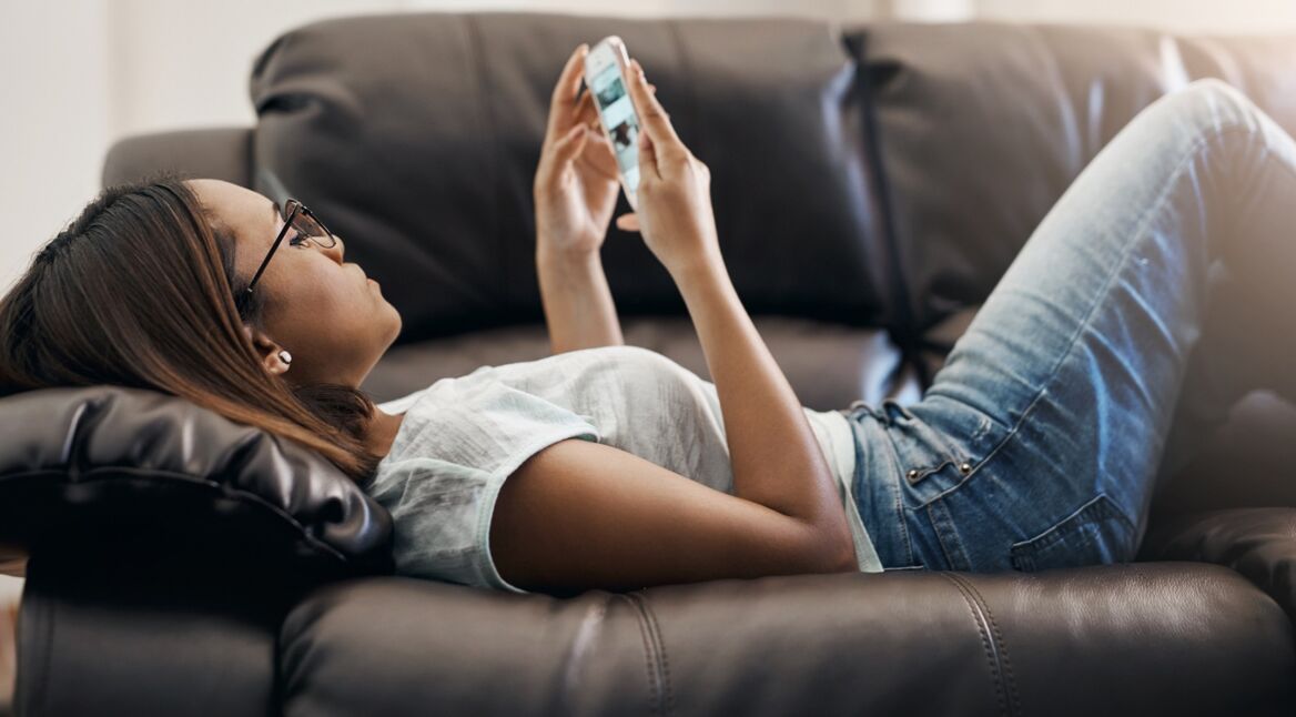 Junge Frau sortiert ihre Fotos auf dem iPhone