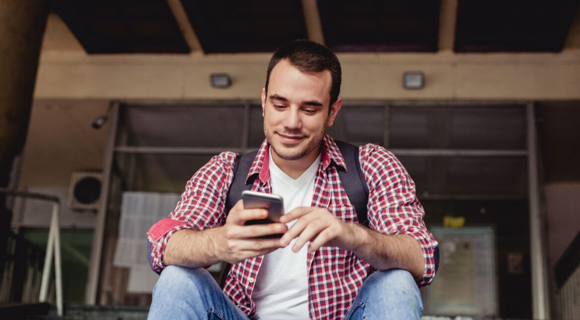 Mann spielt auf Smartphone
