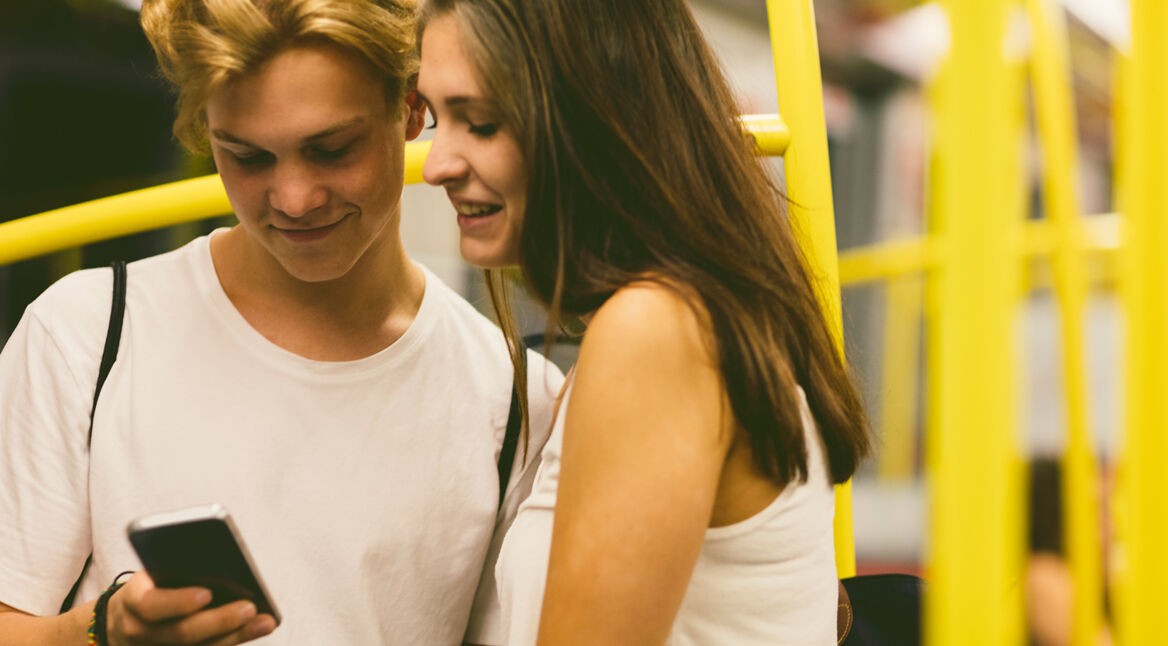 Zwei junge Menschen spielen am Smartphone
