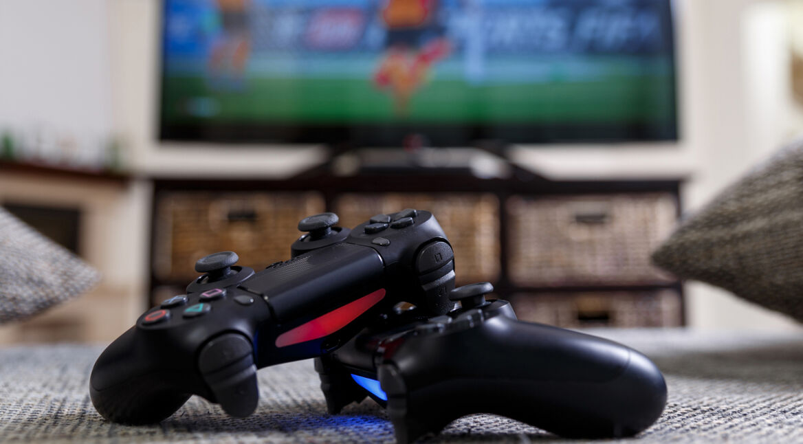 Konsolen-Controller vor TV auf dem Gaming-Highlights für die Play Station 4 gespielt werden