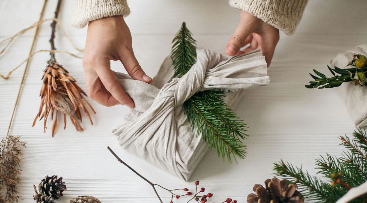 Ein Geschenk, das für nachhaltige Weihnachten in einem Leinentuch verpackt wurde.
