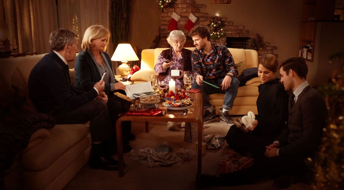 Die Familie Kollinger in der Miniserie "ÜberWeihnachten" beim Geschenkeauspacken.