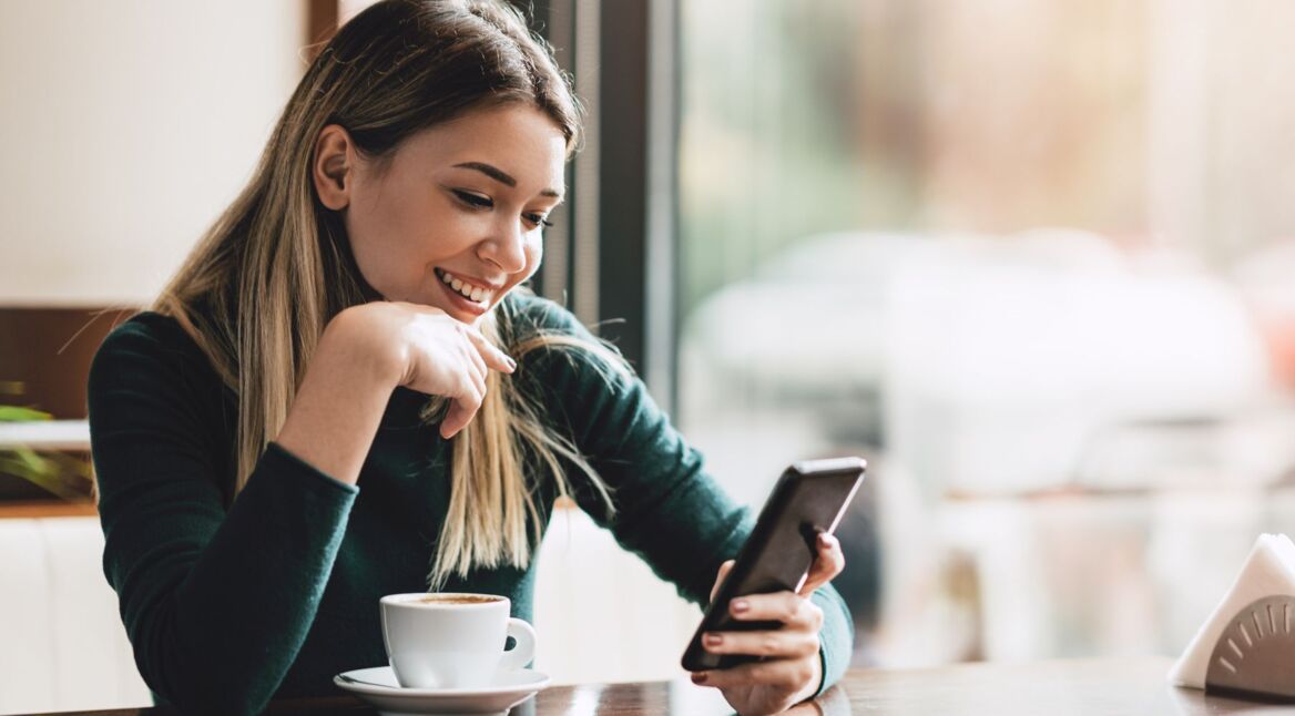 Frau schaut auf ihr Android-Handy.