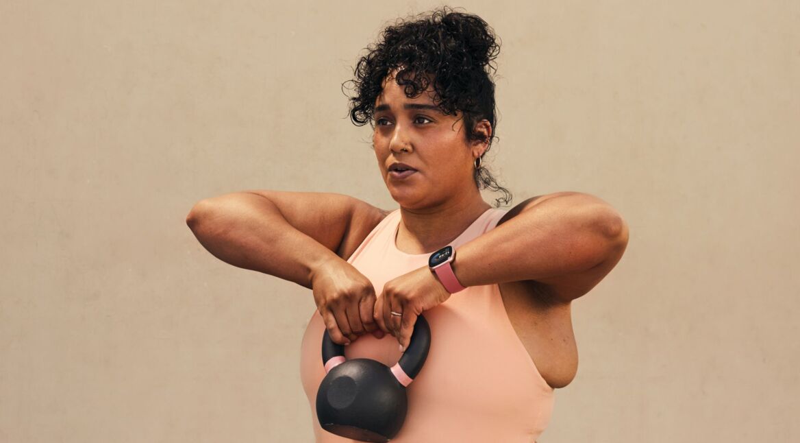 Frau trägt Fitbit Versa 4 beim Sport.